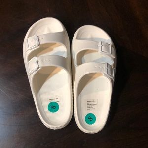 NWOT! Women’s White, Bebe Marbella Slides in size 8!
